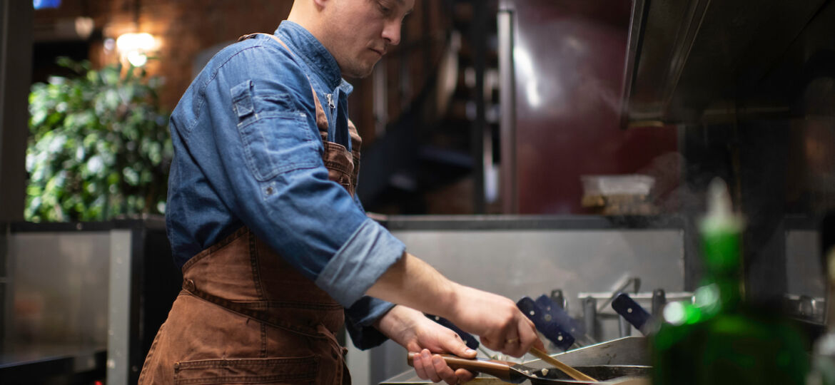 chef-working-in-the-kitchen-in-the-restaurant-33EJWVB